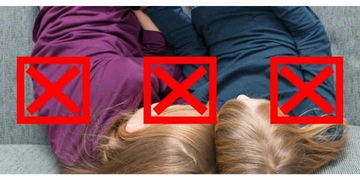 Two girls having their heads close to each other
