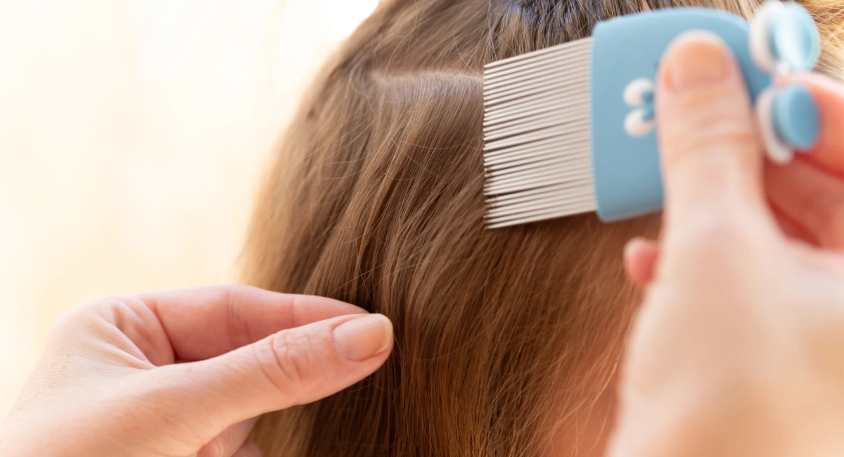 Close up of  a woman examining girls hair.