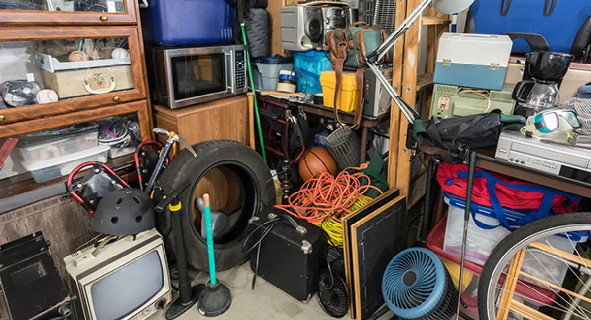 ‘A cluttered garage, with old electronics and other miscellaneous items’