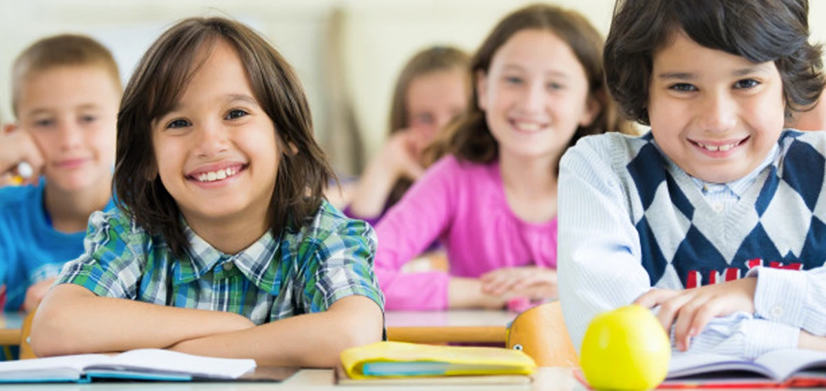 Students in class smiling