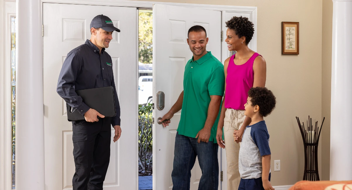 Western Exterminator technician speaks to a family